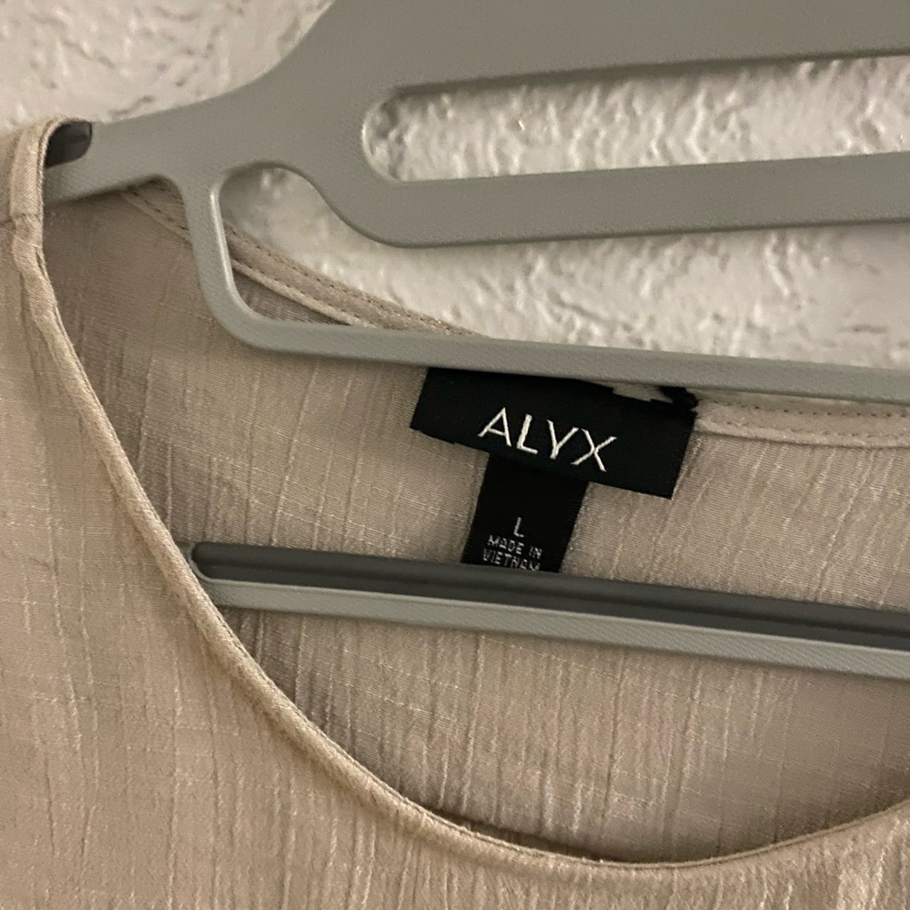 Alyx tan blouse, sheer material, with decorative ruffled sleeves. Size L
